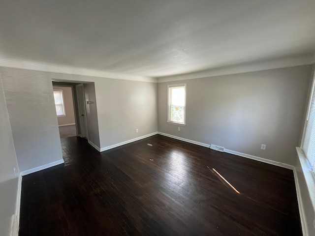 unfurnished room with dark wood-type flooring