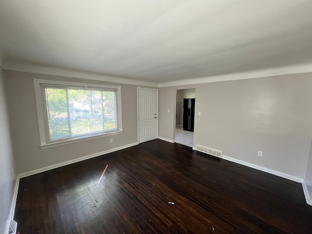 unfurnished room featuring dark hardwood / wood-style flooring