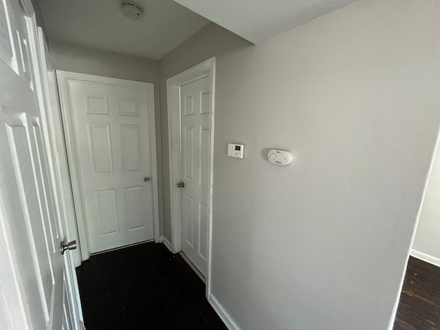 hallway with dark wood-type flooring