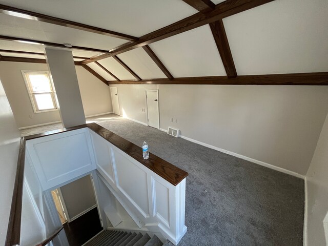 additional living space featuring carpet and lofted ceiling with beams