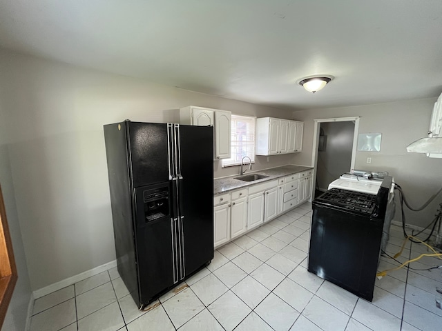 kitchen featuring light tile patterned flooring, sink, white cabinetry, and black appliances