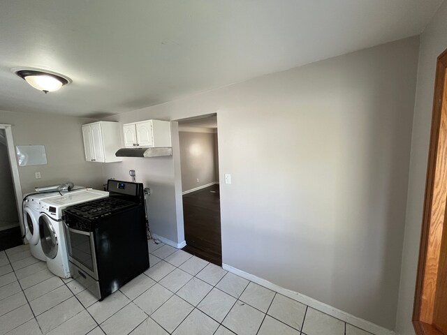 kitchen with white cabinets, light tile patterned flooring, and washing machine and dryer