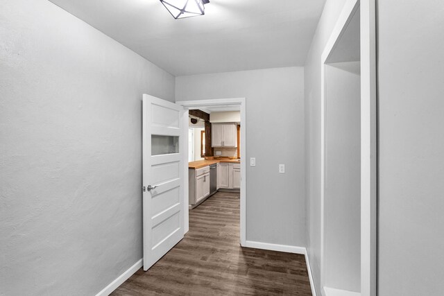 hall with dark hardwood / wood-style flooring