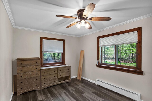 unfurnished bedroom featuring multiple windows, ceiling fan, dark wood-type flooring, and a baseboard radiator