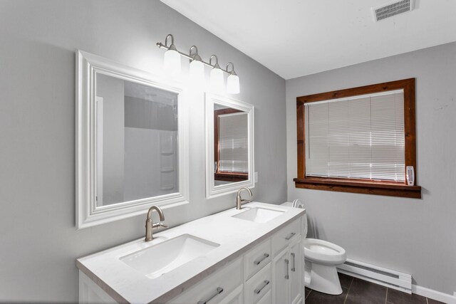 bathroom with toilet, tile patterned flooring, vanity, and a baseboard heating unit