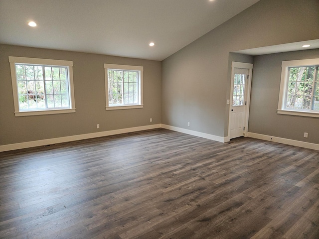 unfurnished room with dark hardwood / wood-style floors and vaulted ceiling