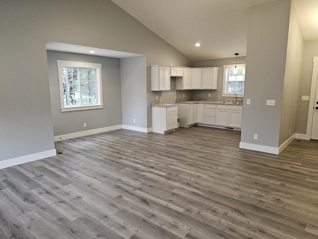 kitchen featuring sink, white cabinets, hardwood / wood-style floors, and plenty of natural light