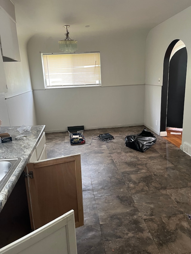 kitchen featuring white cabinets and pendant lighting