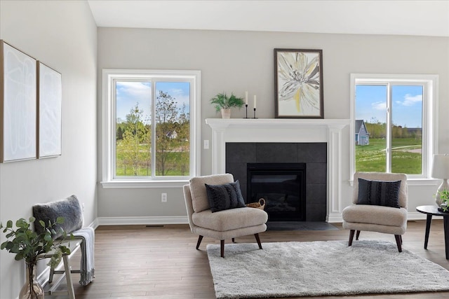 sitting room featuring wood-type flooring and a fireplace