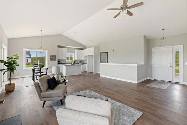 living room with ceiling fan, dark hardwood / wood-style floors, and high vaulted ceiling