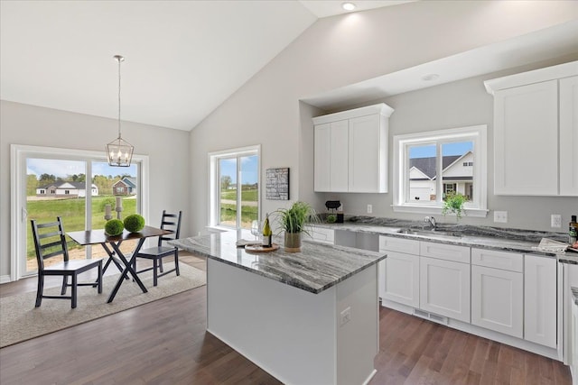 kitchen featuring white cabinetry, decorative light fixtures, dark hardwood / wood-style flooring, and a kitchen island