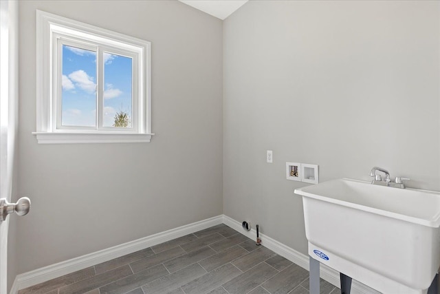 laundry area with hookup for a washing machine and sink