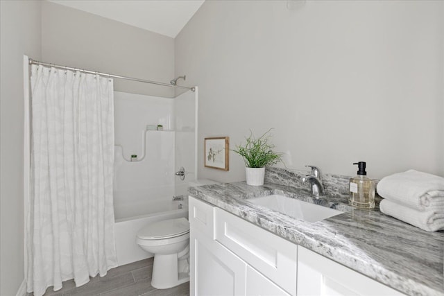 full bathroom with shower / bath combo, hardwood / wood-style floors, vanity, and toilet