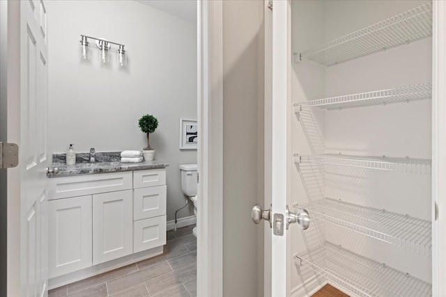 bathroom with vanity and toilet