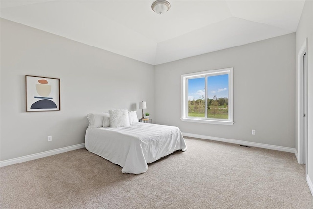 bedroom featuring lofted ceiling and carpet flooring