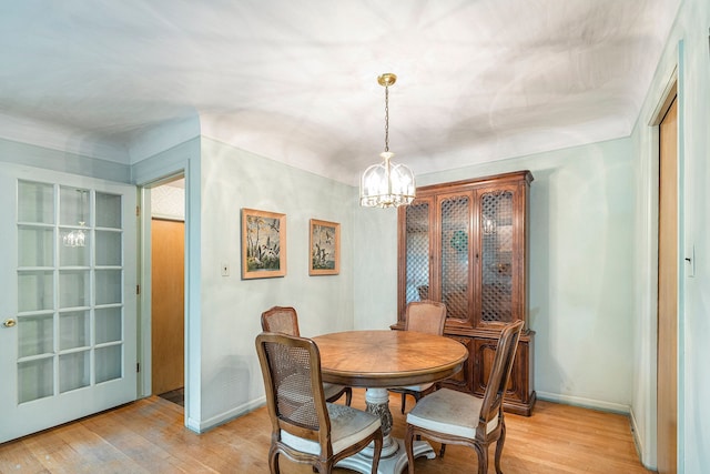 dining room with a chandelier and light wood-type flooring