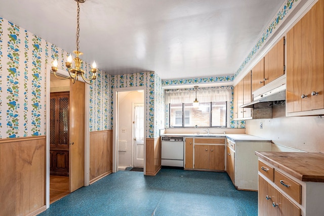 kitchen with a chandelier, sink, white dishwasher, and pendant lighting