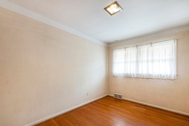 spare room featuring hardwood / wood-style flooring