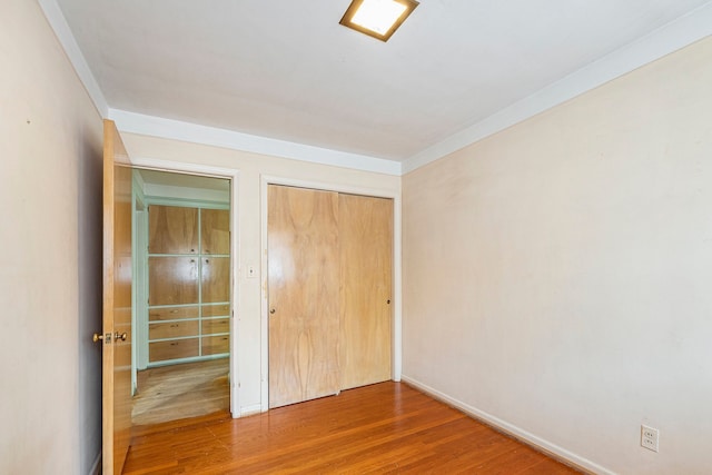 unfurnished bedroom featuring hardwood / wood-style floors and a closet