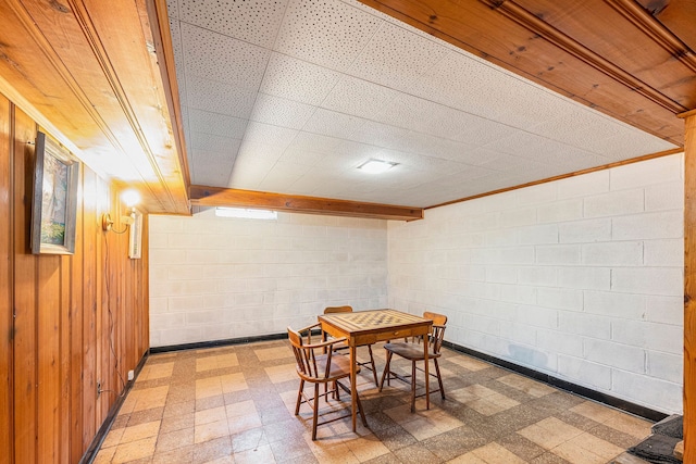 dining room featuring wood walls