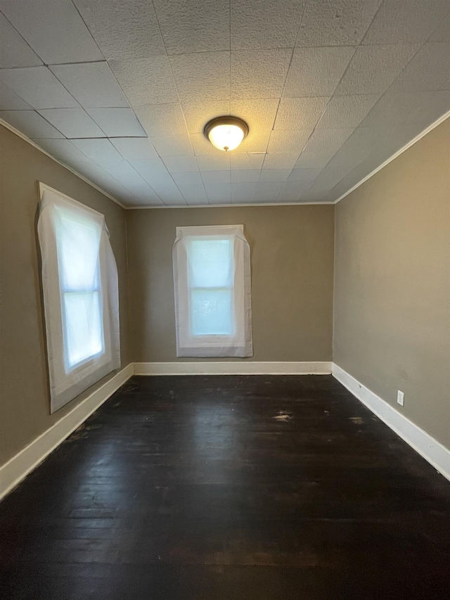 2734 Cumings Ave, Flint, MI 48503 - spare room featuring ornamental molding, healthy amount of natural light, and dark wood finished floors