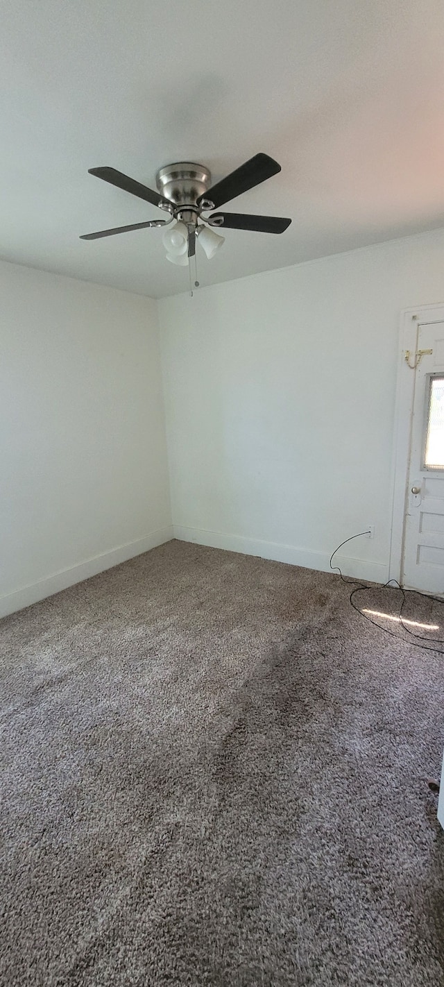 empty room with ceiling fan and carpet floors