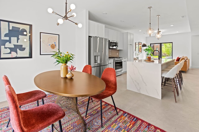 dining room with sink and an inviting chandelier