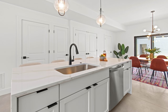 kitchen featuring white cabinets, light stone counters, sink, pendant lighting, and dishwasher