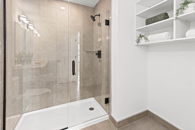 bathroom with tile patterned floors and a shower with shower door