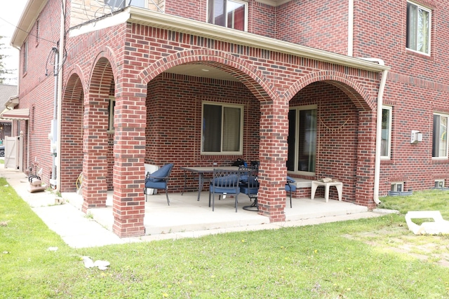 back of house with a patio area and a yard