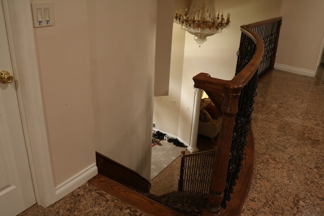 staircase featuring carpet flooring and a notable chandelier