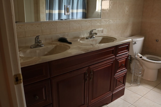 bathroom featuring vanity, backsplash, tile patterned flooring, toilet, and tile walls