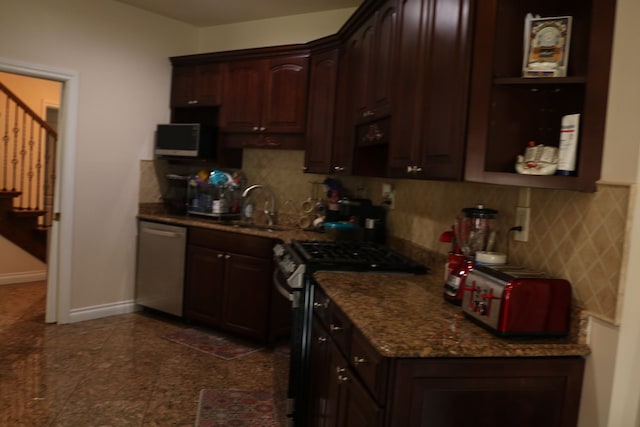 kitchen featuring decorative backsplash, dark brown cabinetry, sink, and appliances with stainless steel finishes