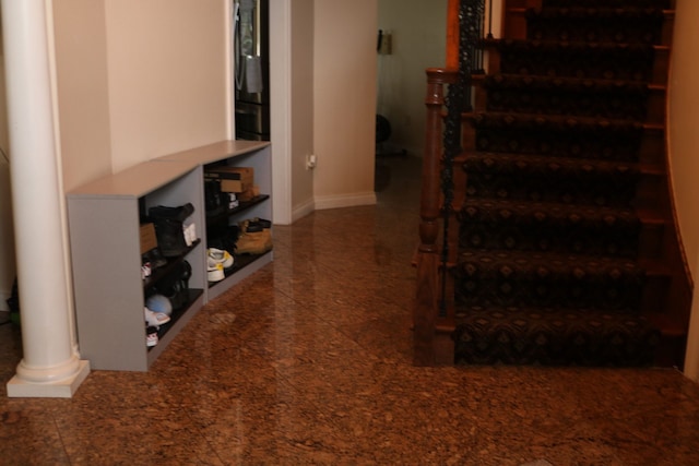 staircase with ornate columns