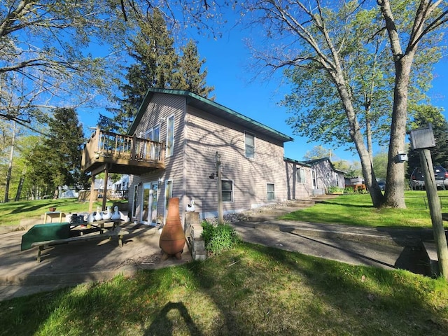 view of side of property with a yard and a patio area