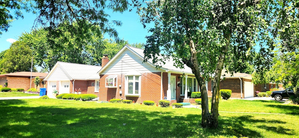 view of front facade with covered porch, a garage, and a front yard