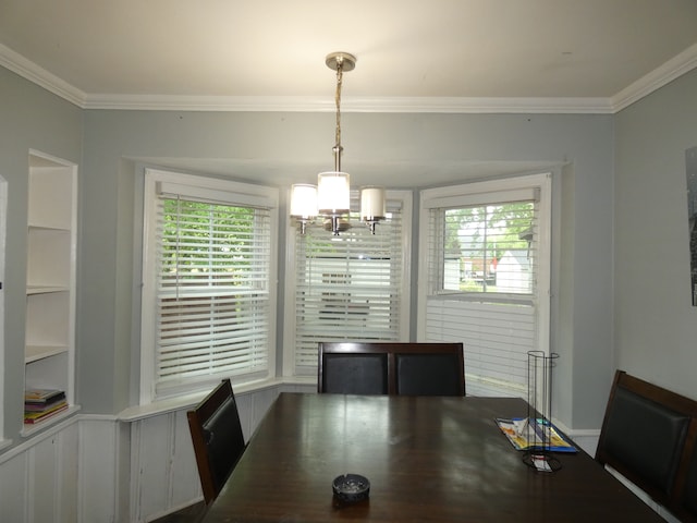 dining space featuring crown molding, a healthy amount of sunlight, and an inviting chandelier