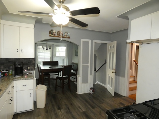 kitchen featuring dark hardwood / wood-style floors, white cabinetry, ceiling fan with notable chandelier, and tasteful backsplash