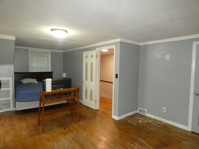 bedroom featuring crown molding and hardwood / wood-style floors