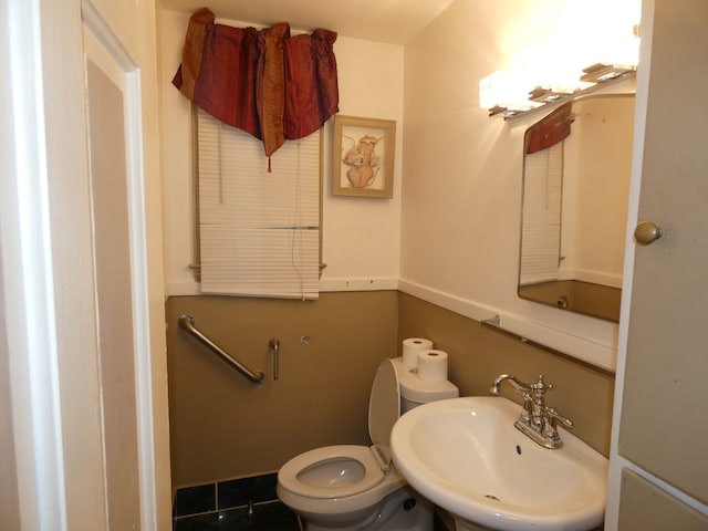 bathroom with tile patterned floors, toilet, and sink