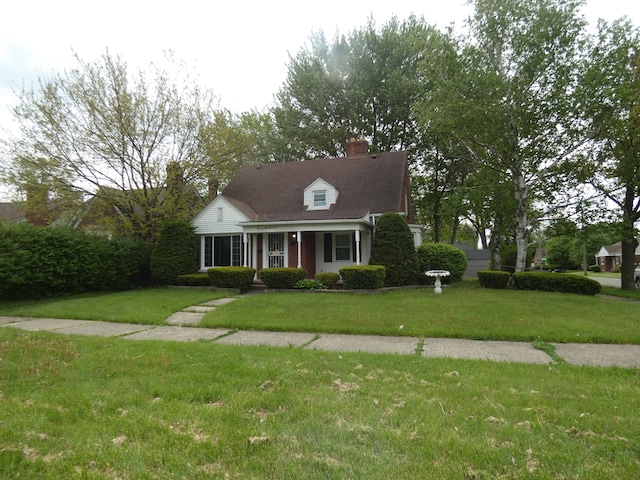 cape cod home featuring a front yard and covered porch