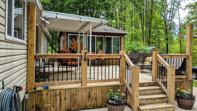 wooden deck with a sunroom