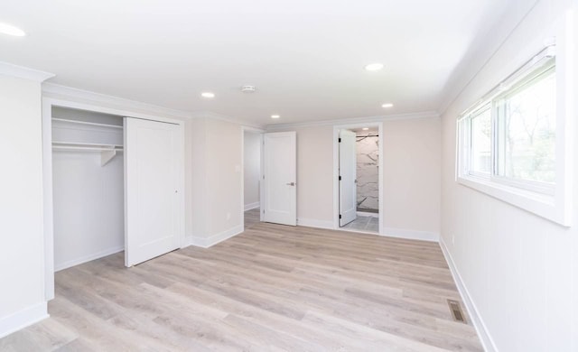 unfurnished bedroom with ensuite bath, light hardwood / wood-style flooring, a closet, and ornamental molding