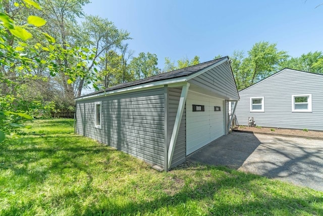 exterior space with a yard and a garage