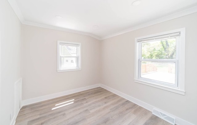 unfurnished room featuring visible vents, baseboards, light wood-style floors, and ornamental molding