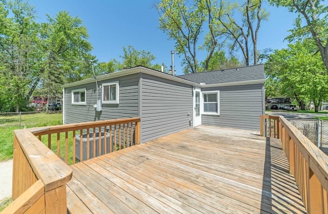 wooden deck with central AC unit and fence