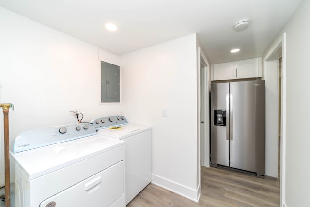 washroom with light wood-style flooring, washer and clothes dryer, electric panel, recessed lighting, and baseboards