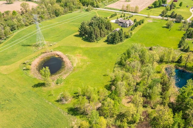 drone / aerial view featuring a rural view and a water view