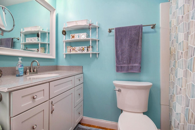 bathroom with wood-type flooring, vanity, toilet, and curtained shower