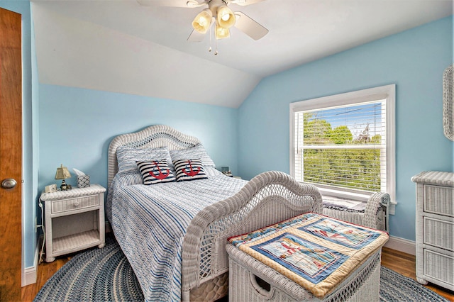 bedroom featuring wood-type flooring, vaulted ceiling, and ceiling fan